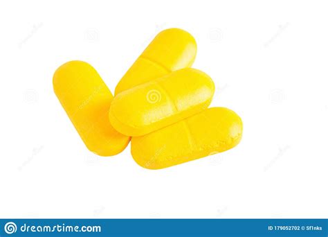 Closeup Of Yellow Pills Isolated On White Background Stock Photo