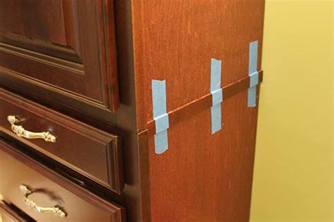 Fix the jig at the bottom of the cabinet to ensure the exact position for each hinge on each door. Use Glue Instead of Nails For Small Wood Trim - Home Construction Improvement