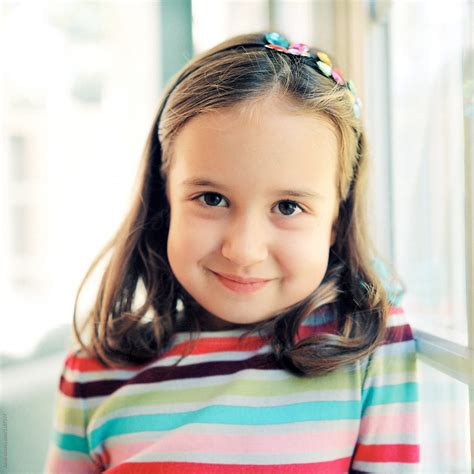 Portrait Of A Cute Young Girl In A Striped Sweater Del Colaborador De