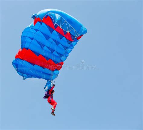 Red And Blue Parachute With Paratrooper In Sky Stock Photo Image Of