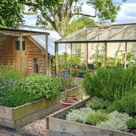 Country Garden With Raised Herb And Vegetable Beds And Greenhouse