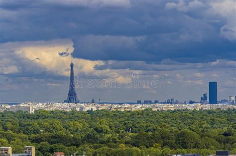 Panorama Of Paris With Eiffel Tower Under Cloudy Sky With Trees From