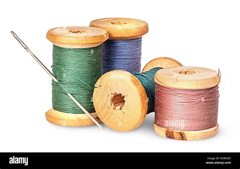 Needle And Multicolored Thread On Wooden Spool Isolated On White