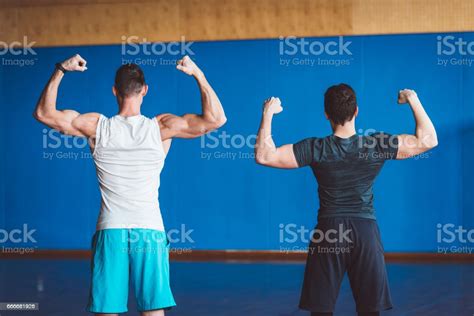 Two Athletic Guys Showing Biceps From Behind Stock Photo Download