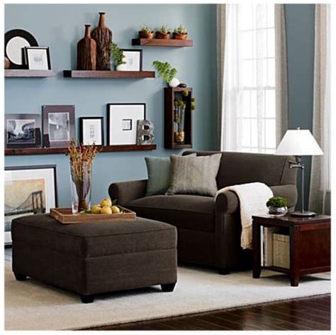 Beige tufted sectional with beige, blue and brown accent pillows with a round brown ottoman & a beige, brown and blue rug. 8 Stylish Small Scale Sofas | Brown living room decor ...