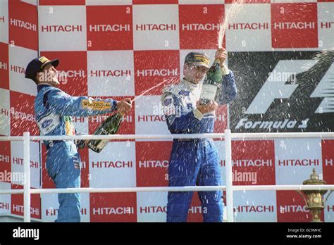 Damon Hill Sprays Champagne Over Michael Schumacher Hi Res Stock