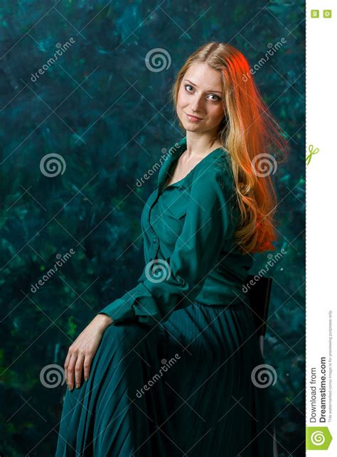 Blonde Girl On A Green Background In A Long Green Dress Stock Image