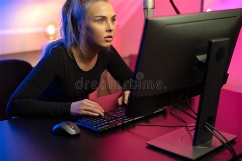 Focused Professional E Sport Gamer Girl With Headset Playing Online