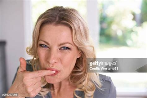 Licking Finger Photos And Premium High Res Pictures Getty Images