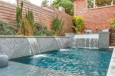 Raised Wall With Custom Glass Tile Two Foot Sheer Pool Water