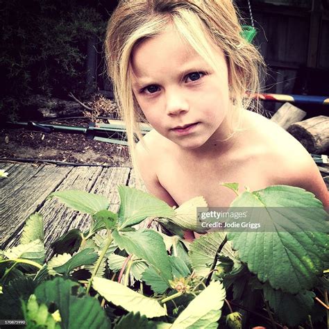 Child Wearing No Clothes Hiding In Garden High Res Stock Photo Getty