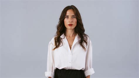 Young Brunette Woman In White Shirt And Black Skirt Is Looking Very Disappointed And Upset While