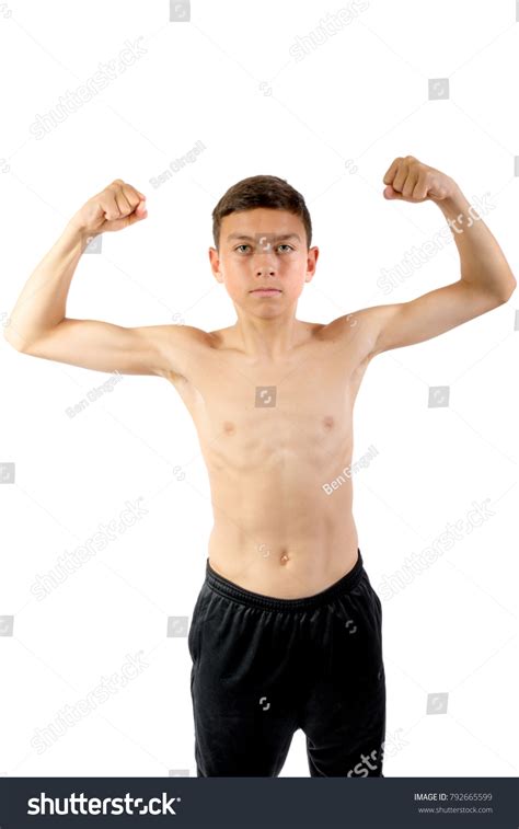Shirtless Teenage Boy Flexing His Muscles Foto Stock 792665599