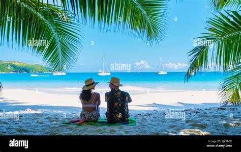 Anse Lazio Praslin Seychelles A Young Couple Of Men And Women On A