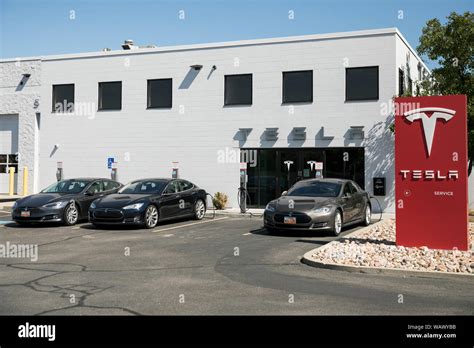 A Logo Sign Outside Of A Tesla Car Dealership In Salt Lake City Utah