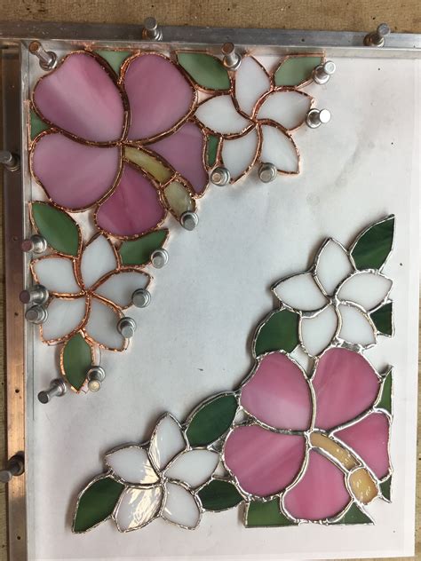 hibiscus and plumeria stained glass to be used as corner pieces on a mirror stained glass