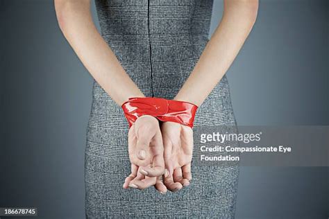 Woman Hands Tied Behind Back Photos And Premium High Res Pictures