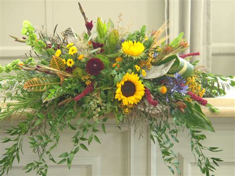 Family owned and operated by judith and mark duffy, judy's village flowers continues to provide beautiful flowers and unparalleled service for over the last 30 years. Natural look casket spray with Birch Bark, Sunflowers ...