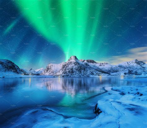 Aurora borealis over snowy mountains containing aurora, northern lights ...