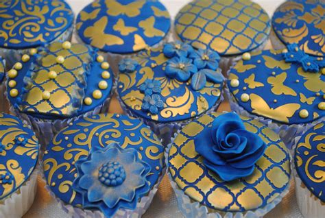 These Royal Blue And Gold Cupcakes Have Been Decorated Using The Cake