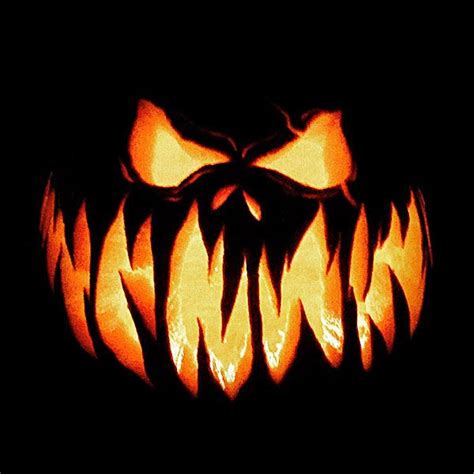 A Carved Pumpkin With Fangs On Its Face