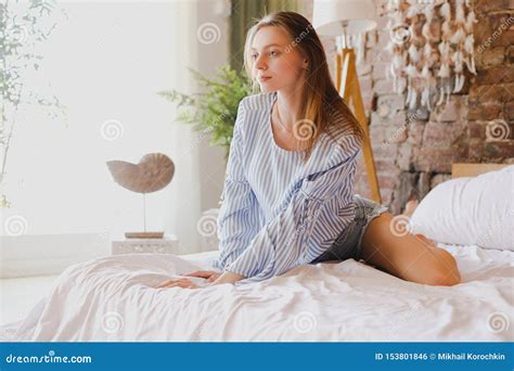 Young Cute Girl Sitting On Bed Beauty Comfort And Relaxation Stock