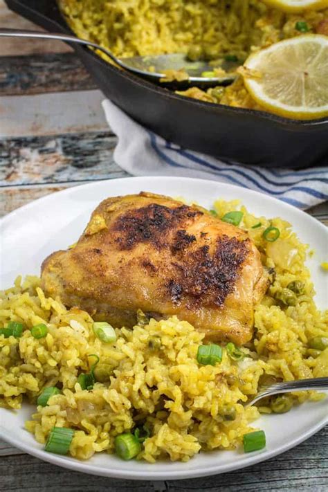 Sprinkle frozen peas on top; One Pot Lemon-Garlic Chicken with Yellow Rice - Dishing Delish