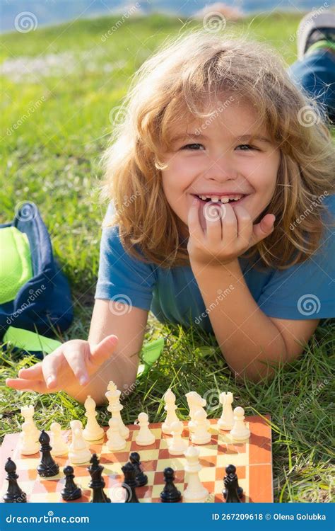 Little Kid Play Chess In Park Child Boy Playing Board Game Outdoor