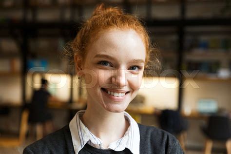 Happy Redhead Lady Student Posing Indoors In Library Stock Image