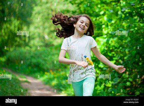 Happy Little Girl Running In Summer Park Stock Photo Alamy