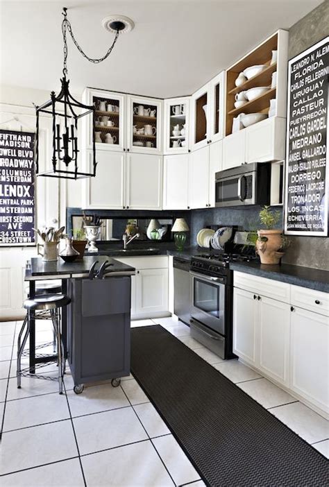 Kitchens without upper cabinets should you go without. Black and white kitchen with double stacked upper cabinets ...
