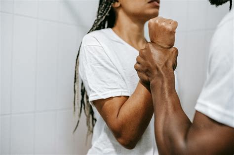 Faceless Muscular Ethnic Man Grabbing Wrist Of Girlfriend During