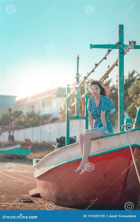Woman Is Sitting On A Beach Boat Relaxing For Summer Beach Vacation