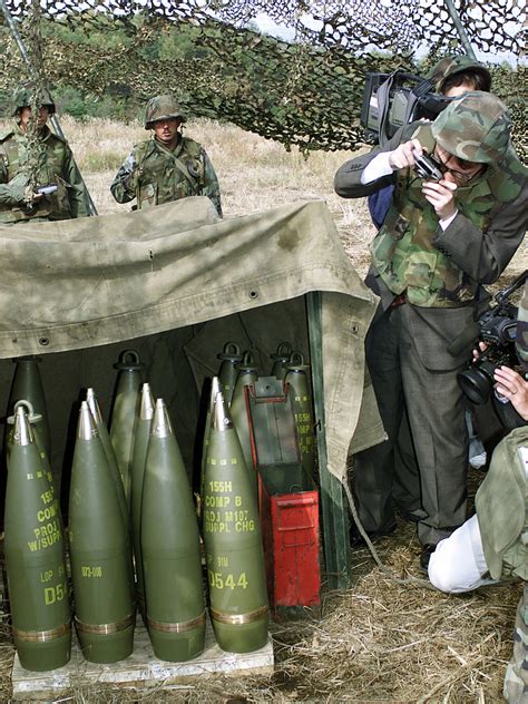 Members Of The Japanese Media Photograph The M107 155mm High Explosive