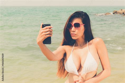 Beautiful Attractive Large Breast Asian Bikini Woman Posing Sexy Portrait On Beach Smart Phone