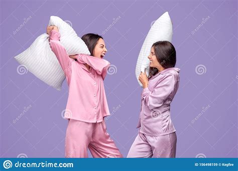 Young Women Having Pillow Fight During Sleepover Stock Image Image Of