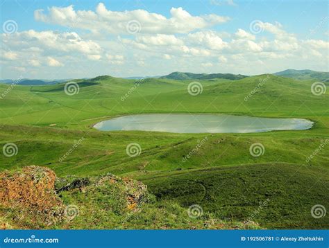 A Picturesque Lake Lying In A Valley Surrounded By High Hills Stock
