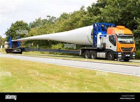 Wind Turbine Blades On Transport Trucks At A Motorway Service Station