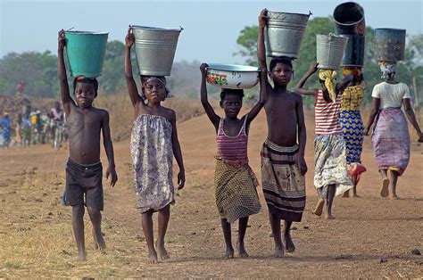 African Children Carrying Water On By John Miles