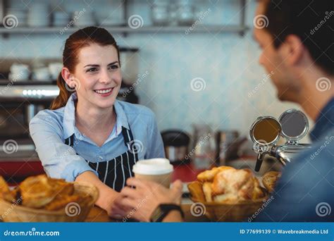 Happy Barista Offering Coffee To Customer At Cafe Stock Image Image