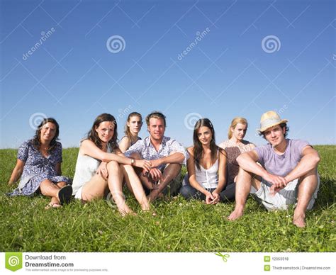 Group Of People Sitting On The Grass Stock Photo Image Of Attractive