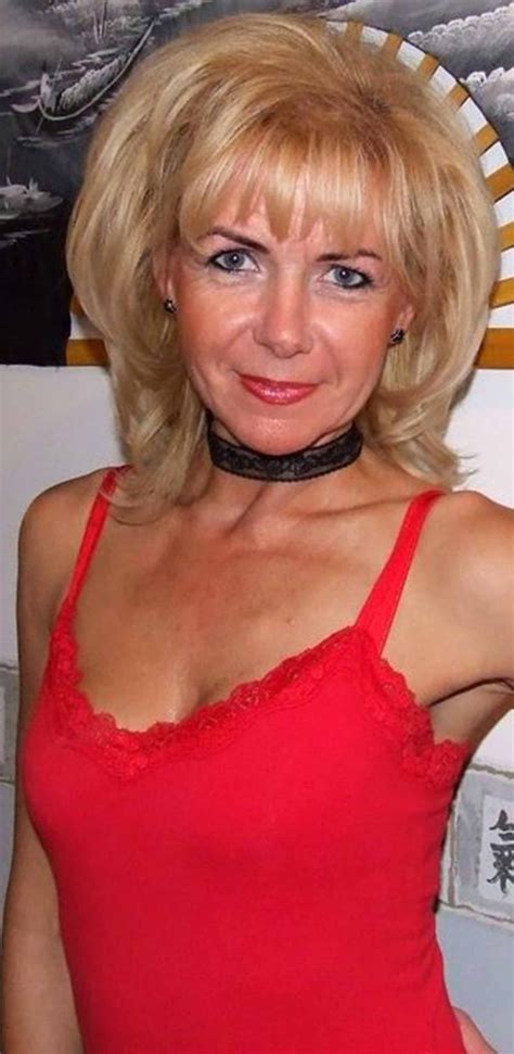 A Woman In A Red Top Posing For The Camera