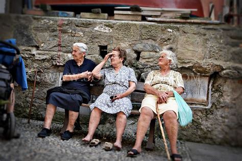 Photo Of Three Elderly Women Sitting On A Bench In Vernazza Italy