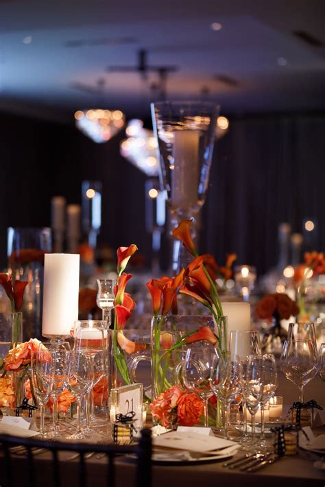 Their business is recorded as. A mixture of candles and clear vases with orange flowers ...