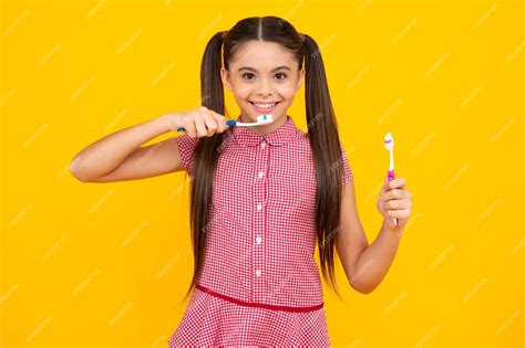 Premium Photo Teenager Girl Brushing Her Teeth Over Isolated Yellow Background Daily Hygiene