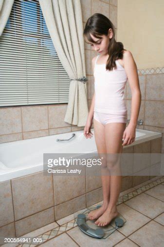 Girl Standing On Scales In Bathroom Bildbanksbilder Getty Images
