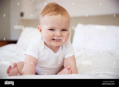 Happy Baby Boy Sitting On Parents Bed Stock Photo Alamy