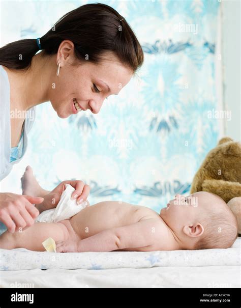 Mother Changing Baby S Diaper Stock Photo Alamy