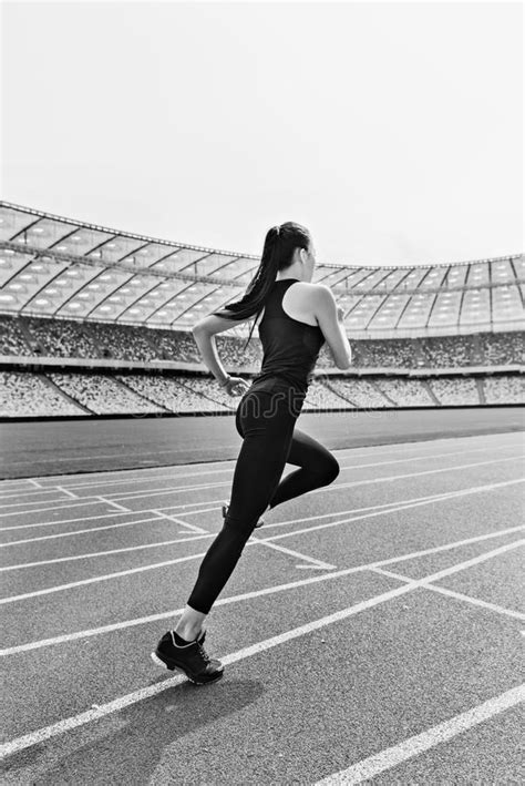 Young Fitness Woman In Sportswear Running On Running Track Stadium