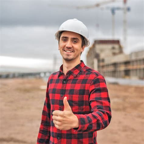 Civil Engineer In A White Helmet On The Background Of Construction